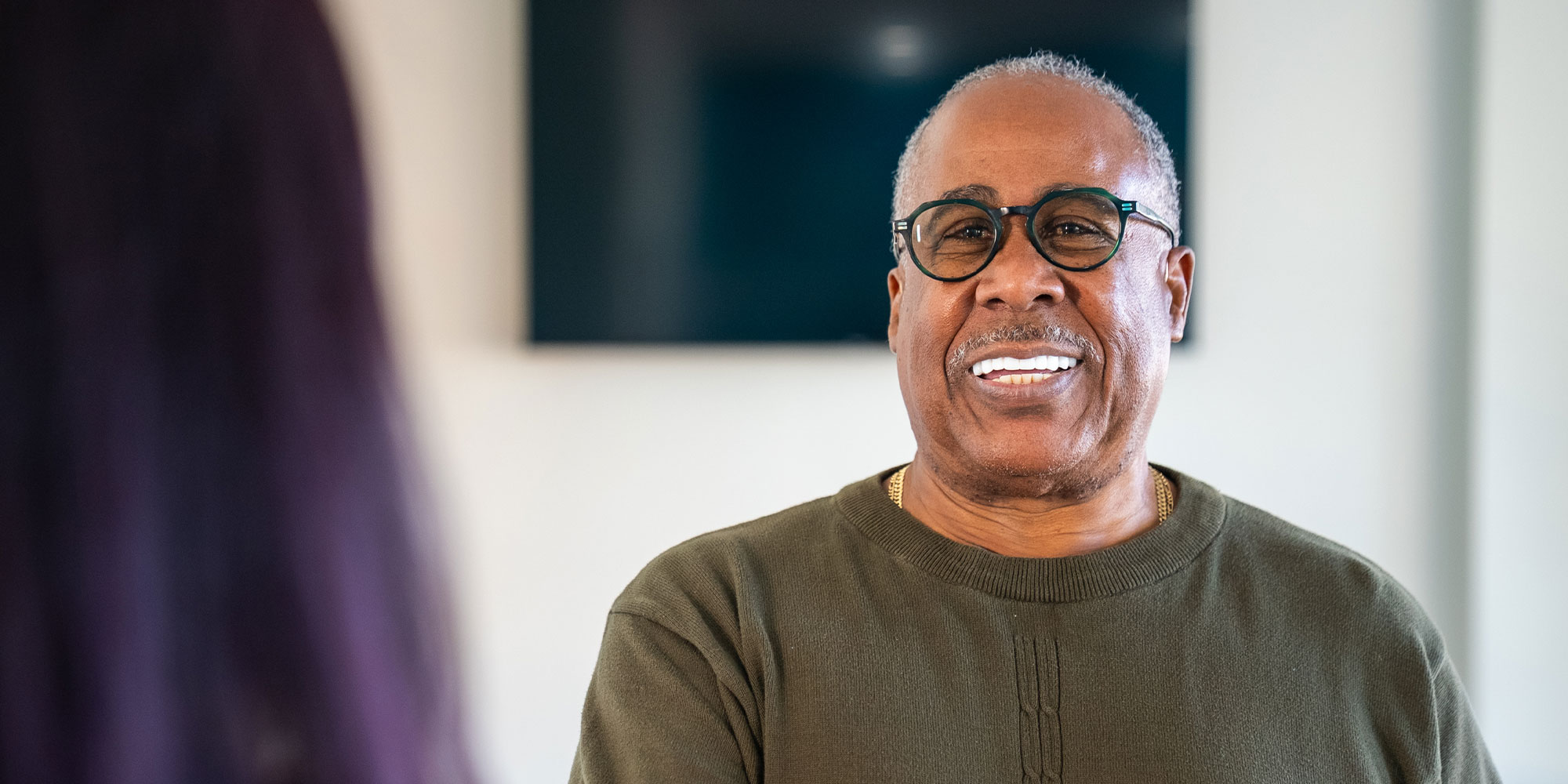 Patient smiling while discussing dental implant candidacy